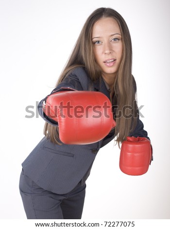 portrait of business woman boxing in red gloves. business activity
