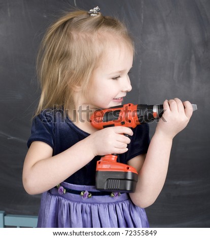portrait of little cute girl with drill toy