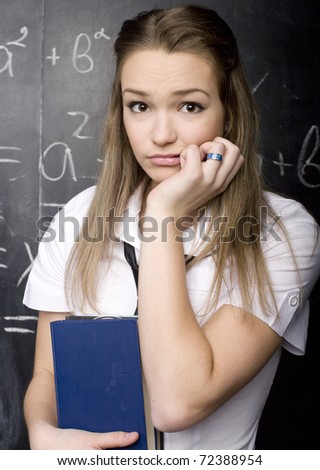 portrait of beauty happy student with books near blackboard