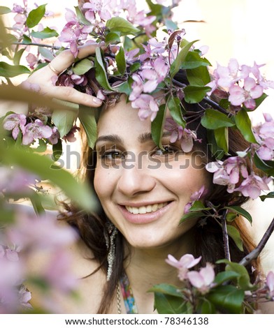 portrait of pretty young woman with flowers smiling