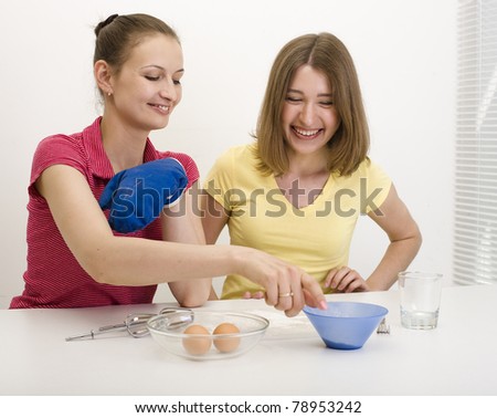 portrait of two woman friends cooking