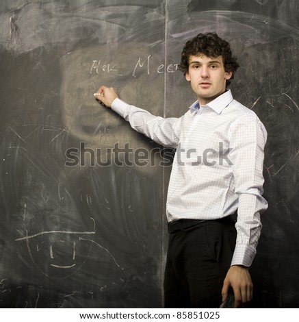 The young emotional student in class room, writing on blackboard
