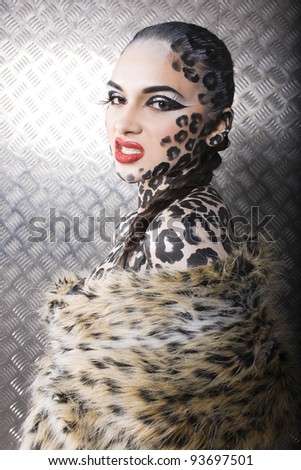 close-up portrait of beautiful young european model in cat make-up and bodyart