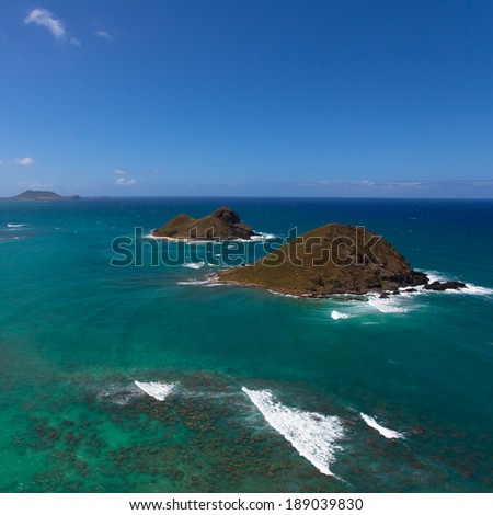 Aerial overview of Oahu\'s coastal islands and bright blue waters