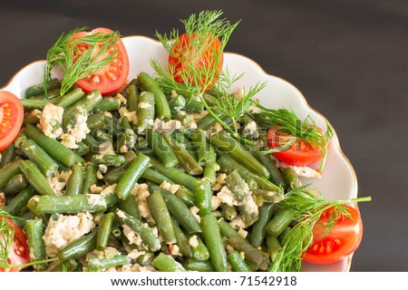 Salad of green beans with eggs and tomatoes.