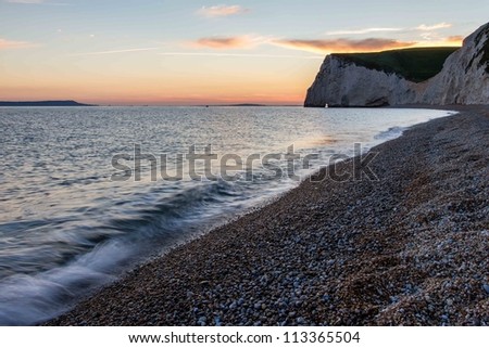 Durdle Door beach at sunset looking towards Bats Head, Dorset Jurassic Coast