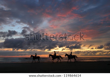 Sunset horse riders, Pantai Dalit beach in Borneo
