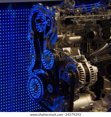 Cut out of motor engine, displayed in front of a blue LED wall