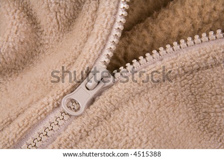 Detail of zip in a brown jacket.