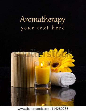 postcard of aromatherapy with candles an flower on dark background
