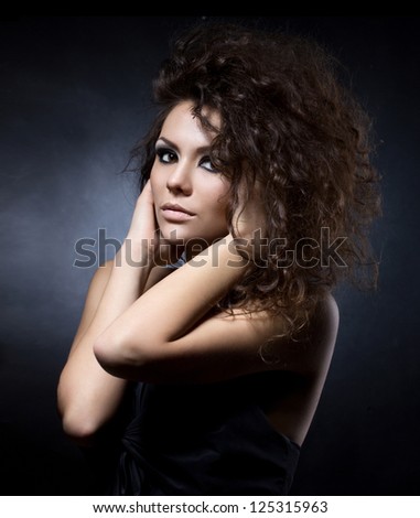 close up portrait of charming young woman on dark background