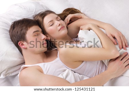 Young man and beautiful woman sleeping in a white bedding