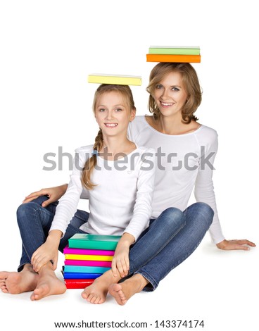 mother and daughter in clothing sportive style sitting on the floor with books on heard isolated on white