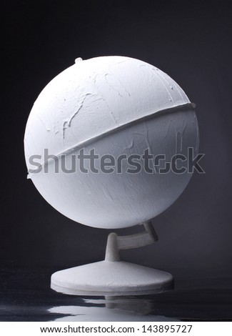 old white painted globe on dark background