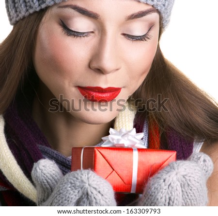 closeup portrait of a beautiful young woman in hat and gloves with gift  box on white background