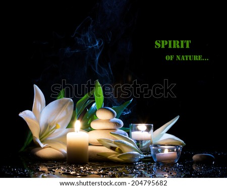 spa still life with white lily, stones and  burning candles on  black bright table with water drop,  on black background