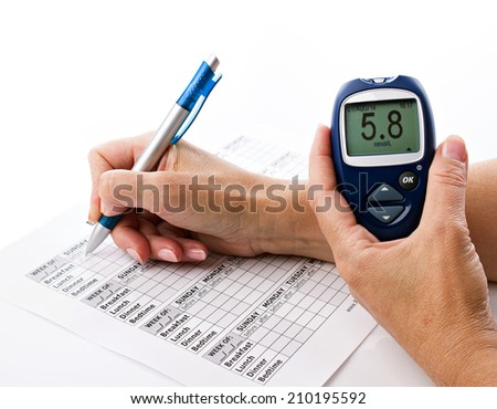 senior woman\'s hands writing data from glucometer to medical form on white background