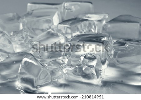 many different melt ice cubes on grey background