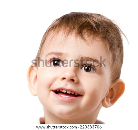 beautiful little boy with brown eyes and long eyelashes looking up on white background