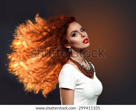 Beautiful young woman portrait with long curly orange hair