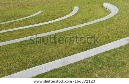 Grass area in park with concrete curbs