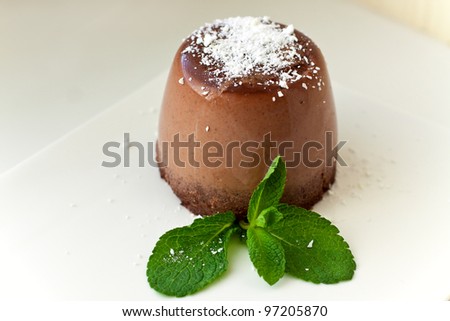 Chocolate pannacotta with mint leaves. Italian dessert