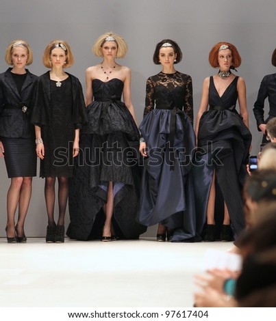 TORONTO - MARCH 13: Models stand at the end of the runway in the Lundstrom Collection runway show for the Fall/Winter 2012 season at Toronto\'s World Mastercard Fashion Week on March 13, 2012 in Toronto, Canada.