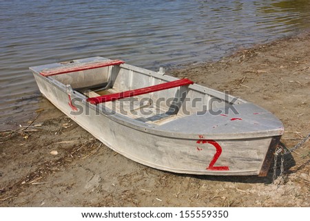Worn boat at the lakeside