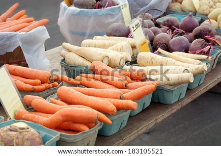 Outdoor farmers\' market stand with various vegetables for sale