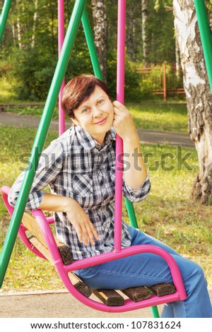Woman sits on a swing