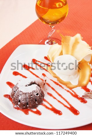 Chocolate pudding and ice cream with a glass of apple juice