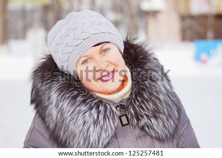 Beautiful woman in a winter coat with fur collar