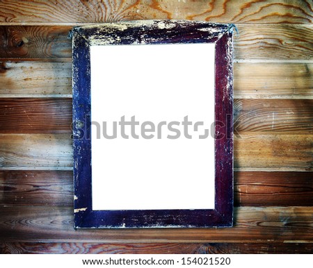 Old vintage wooden frame with empty space for text hanging on the wall