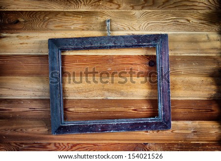 Old vintage frame hanging on the wooden wall