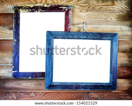 Two old vintage wooden frames with empty space for text hanging on the wall
