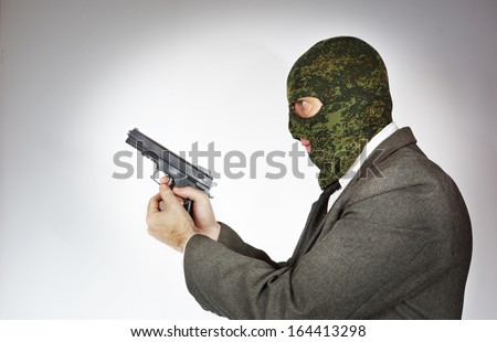 Killer wearing mask with a gun