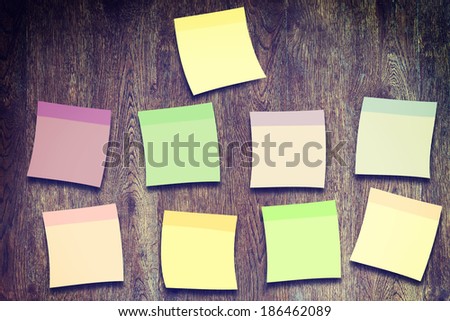 Blank multicolored stickers on the wooden wall