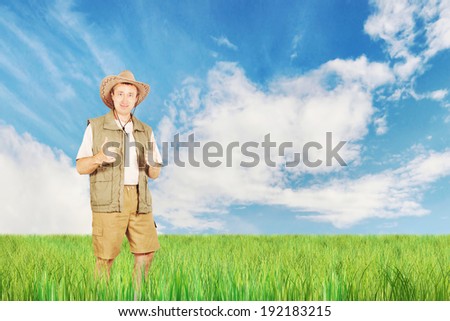 Bright summer landscape with a happy man on the field