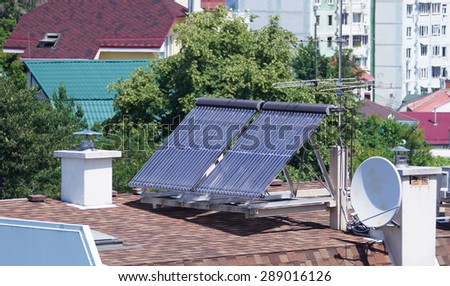 Solar energy collectors for heating the house stand on the roof