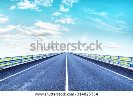 Empty lonely highway goes ahead to horizon