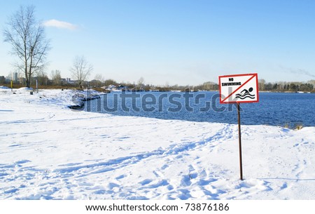 snow-covered beach and sign 