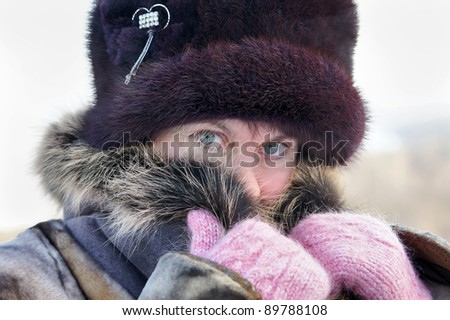Cold weather. The woman muffles up in a fur collar