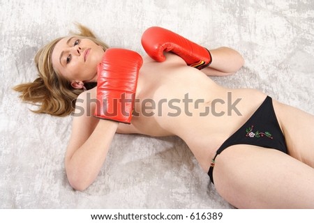 Pretty naked blond woman with red boxing gloves