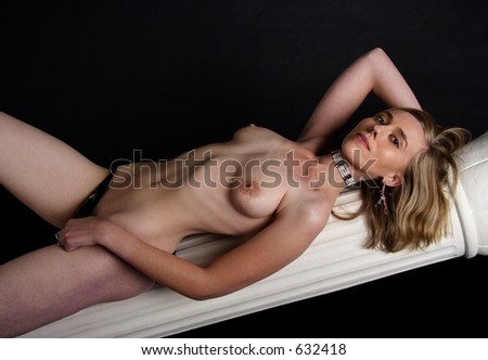 stock photo Pretty naked blond woman lying on a column