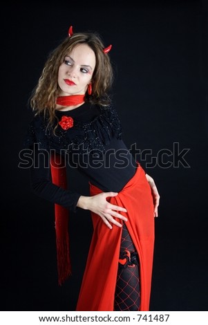 Beautiful brunette woman dressed like a red devil