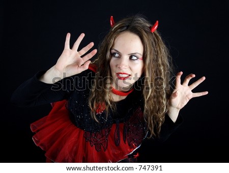 Beautiful brunette woman dressed like a red devil
