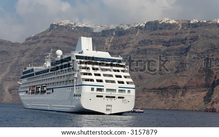 Cruise ship with the cliff line of a mediterranean island
