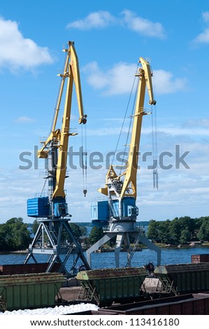 two of the crane loads cars in sea port