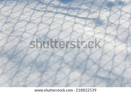 background of the drawing shadows on the snow from a metal grid