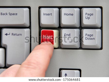 Finger pressing panic button on computer keyboard